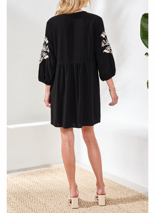 Back view of Tribal Elaine black dress showing floral embroidery pattern and flowing rayon-linen fabric silhouette
