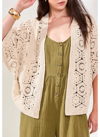 Woman wearing Tribal Naturally Crochet Cardigan layered over olive gauze jumpsuit.