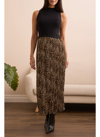 Model wearing Tribal Leopard Dress in black knit top and leopard midi skirt, styled with ankle boots.