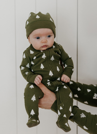 L’ovedbaby organic cotton green tree print thermal onesie and matching pom-pom cap.
