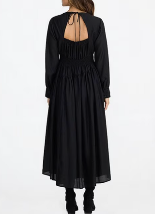 Black long-sleeve dress with open back on a white background