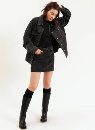 Full outfit view with Daze Sparkle Stash Skirt styled with a  black denim jacket and boots.
