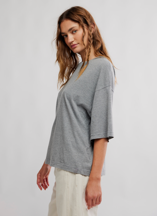 Woman wearing a gray sweater on a white background