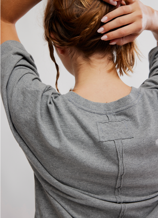 Back detail of Free People Basic B Tee showing raw seam and stitched patch — August Boutique.