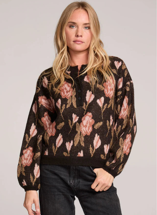 Model wearing Saltwater Luxe Leilani Sweater front view with floral pattern and henley neckline.