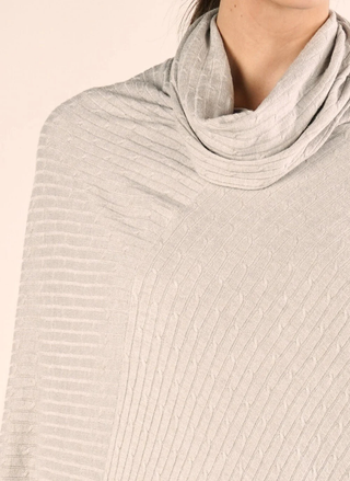 Close-up of ribbed knit and cowl neckline texture detail.