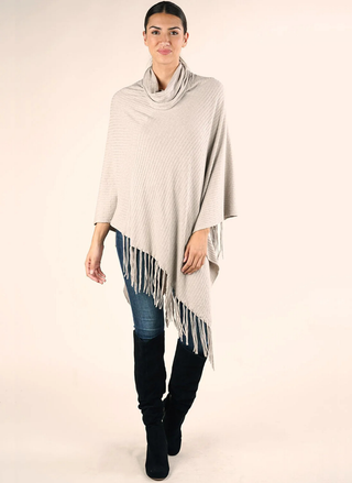 Carrie Cowl Neck Fringe Poncho in beige — ribbed knit poncho with cowl neck and fringe hem