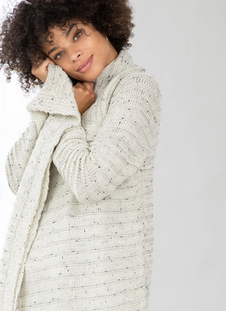 Close-up of speckled knit texture and soft shawl collar detail.