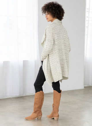 Back view showing relaxed fit and draped hemline.
