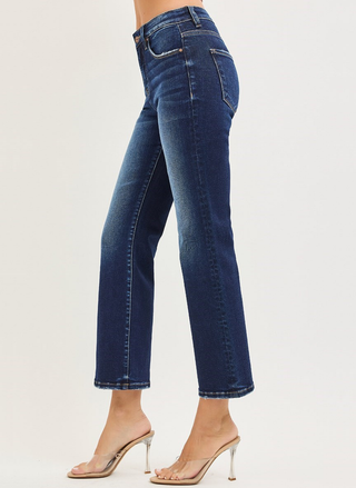 Blue jeans worn by a person on a light gray background