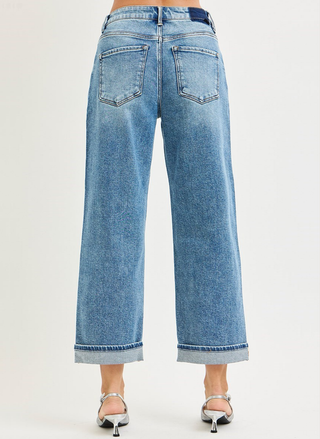 Blue jeans worn by a person on a white background