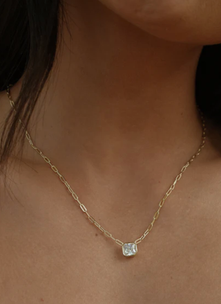 Model wearing Dakota Necklace with adjustable gold chain and single stone pendant.