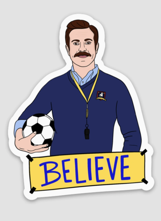 Illustrated motivational sticker with man holding soccer ball and “Believe” banner — positivity and encouragement design.