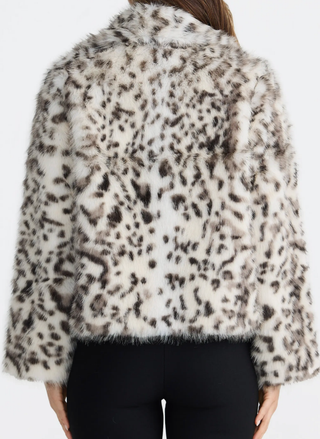Leopard print fur coat worn by a person on a white background