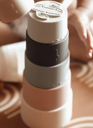 Close-up of a white and gray bottle with a logo on a blurred background