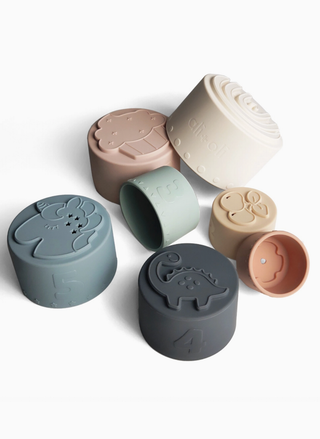 Set of silicone cups with animal designs on a white background