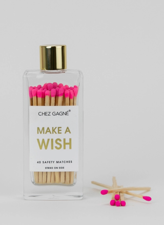 Bottle of matches with 'Make a Wish' text and pink matches on a white background