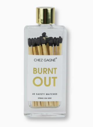 Bottle of matches labeled 'Burnt Out' by Chez Gagne on a white background