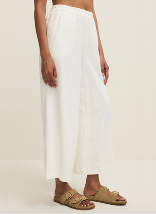 Side view of the white Z Supply Scout Linen pant on a model.