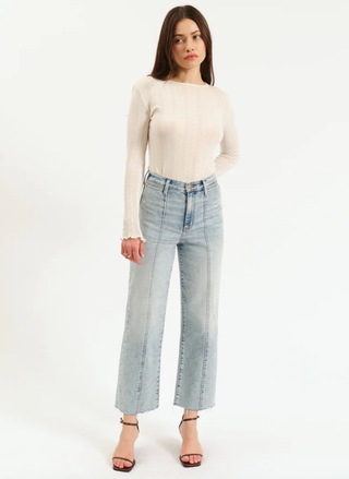 Woman wearing DAZE Pleaser High Rise Ankle in Cupid.  She has on a white long sleeve top and sandals. 