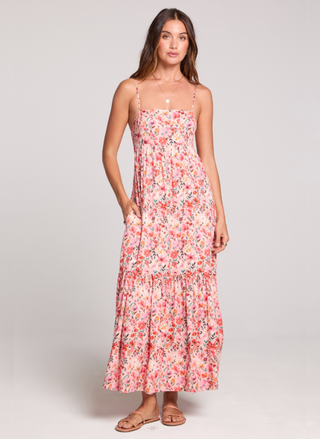 Woman wearing a floral dress on a plain background