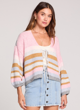 Model at August Boutique wearing the Saltwater Luxe Kiah Striped Tie Cardigan featuring colorful stripes and dramatic gigot sleeves.