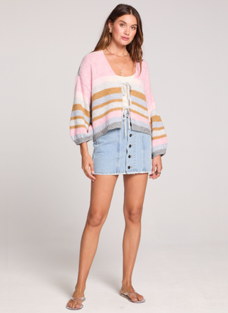 Model at August Boutique wearing the Saltwater Luxe Kiah Striped Tie Cardigan featuring colorful stripes and dramatic gigot sleeves.