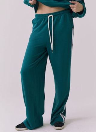 Teal tracksuit with white drawstring and side stripe on a light gray background