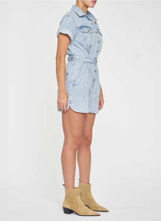 Side view of the Topanga Denim Romper showing the curved hem and comfortable sleeve length on a model.