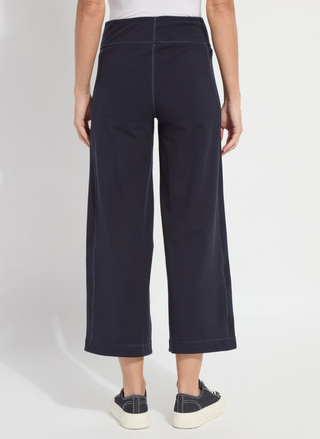 Navy blue wide-leg pants worn by a person on a white background