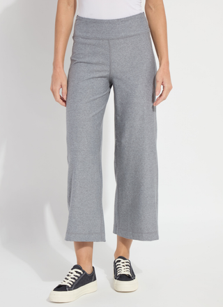 Person wearing gray wide-leg pants on a white background