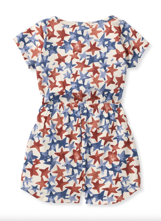 Back view of the infant star print romper showing the elasticized waist and short sleeves.
