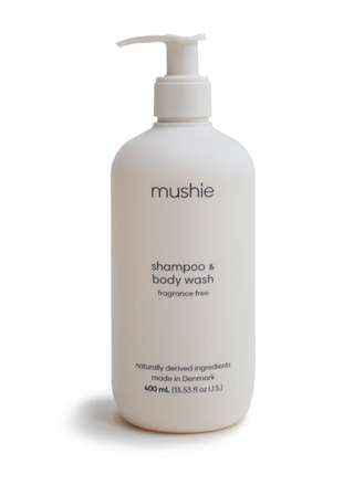 A tall, minimalist white pump bottle of Mushie Shampoo & Body Wash (400mL) on a clean white background.