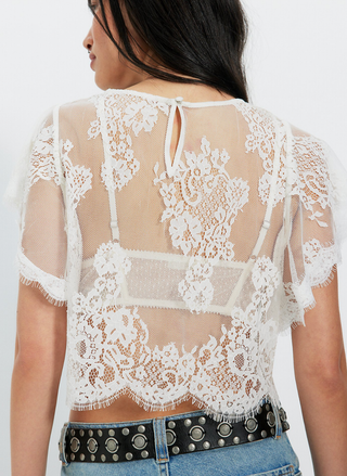 Back view of the black Lunar Ash Lace Top showing the sheer lace detail and back keyhole closure.