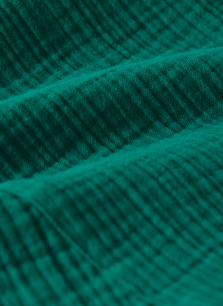 Close-up of teal fabric with a textured pattern
