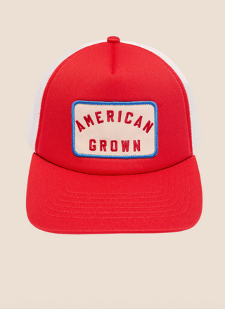 Flat lay product view of the Z Supply red foam trucker hat featuring the embroidered "American Grown" front patch and white mesh backing.