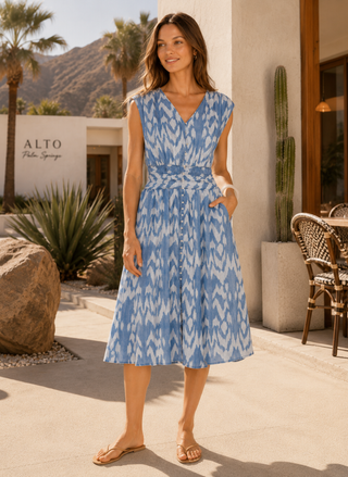 Front view of a model styling the sleeveless blue and white ikat print Velvet Heart Kaulana Denim Dress with her hand in her pocket.