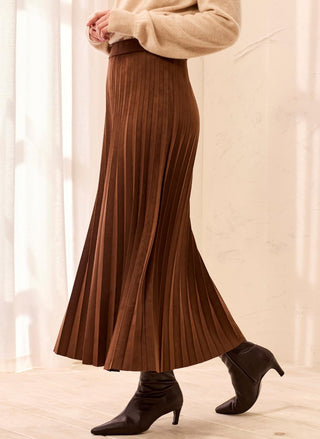 Woman wearing the rich brown TRIBAL Faux Suede Pleated Maxi Skirt paired with a cream knit sweater and dark leather boots.