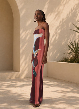 Woman wearing the Dress To Brisa Strapless Tulle Maxi Dress featuring a large calla lily graphic print in burgundy, coral, and soft blue tones.