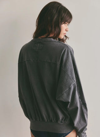 Women's washed black oversized long sleeve pocket tee with crew neck by Free People