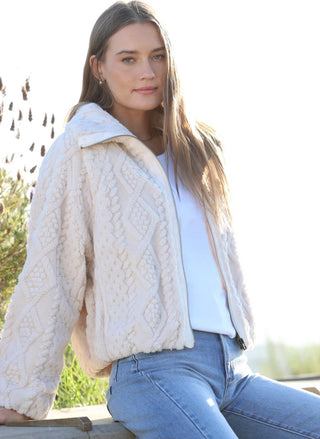 Ivory plush cable jacket by Dylan with elastic cuffs and hem styled with denim - August Boutique
