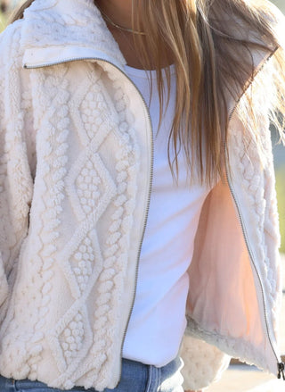 Detail of the raised cable-knit texture on the Dylan So Cozy ivory zip jacket