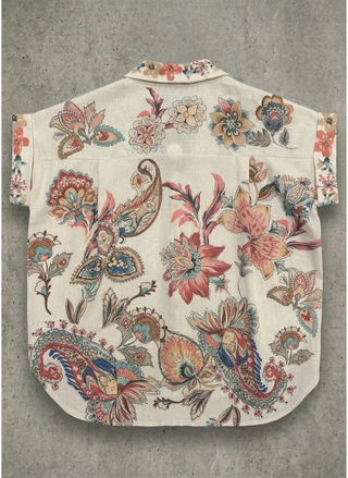 Floral and paisley patterned shirt on a textured gray background