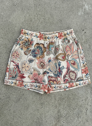 Floral patterned shorts on a concrete surface