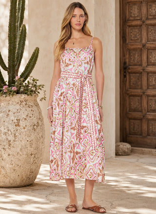 Full-length front view of the model wearing the Current Air Medallion Pleated Midi Dress with the self-tie waist belt, paired with flat brown leather sandals.