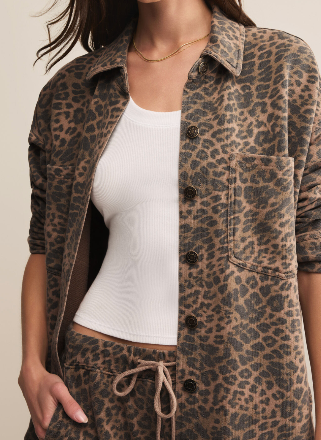 Woman wearing Z Supply All Day Knit Leopard Jacket in black and tan print, oversized fit with button-front closure and chest pockets.