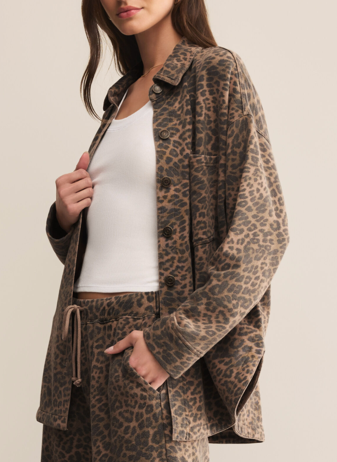 Woman wearing Z Supply All Day Knit Leopard Jacket in black and tan print, oversized fit with button-front closure and chest pockets.