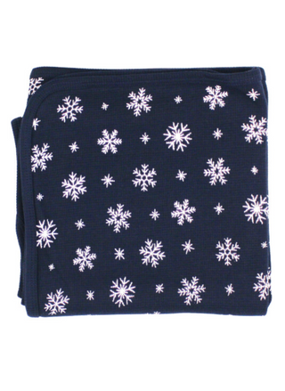 Folded navy snowflake thermal blanket made from organic cotton