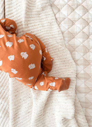 Close-up of ghost print on L’ovedbaby organic cotton baby onesie