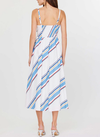 Front and back views of the Current Air Juliette V-Neck Wrap Midi Dress: a white cotton poplin midi dress with adjustable spaghetti straps, V-neck wrap bodice, sky blue/navy/red/beige diagonal stripes, smocked back panel, side seam zipper, and self-fabric waist tie, modeled with silver slide sandals.